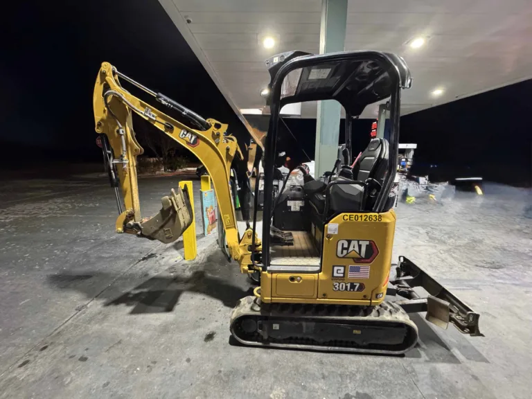 CAT mini excavator at a fuel station getting fueled up