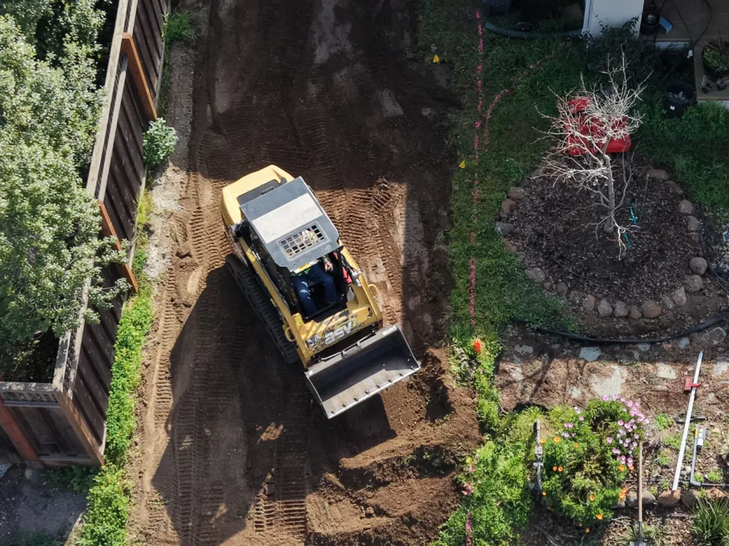 Track loader moving dirt on a residential project site